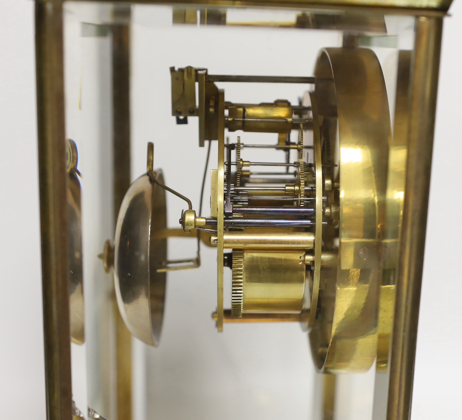 An early 20th century French brass four-glass mantel clock with enamel dial inscribed Garnier, 36cm high